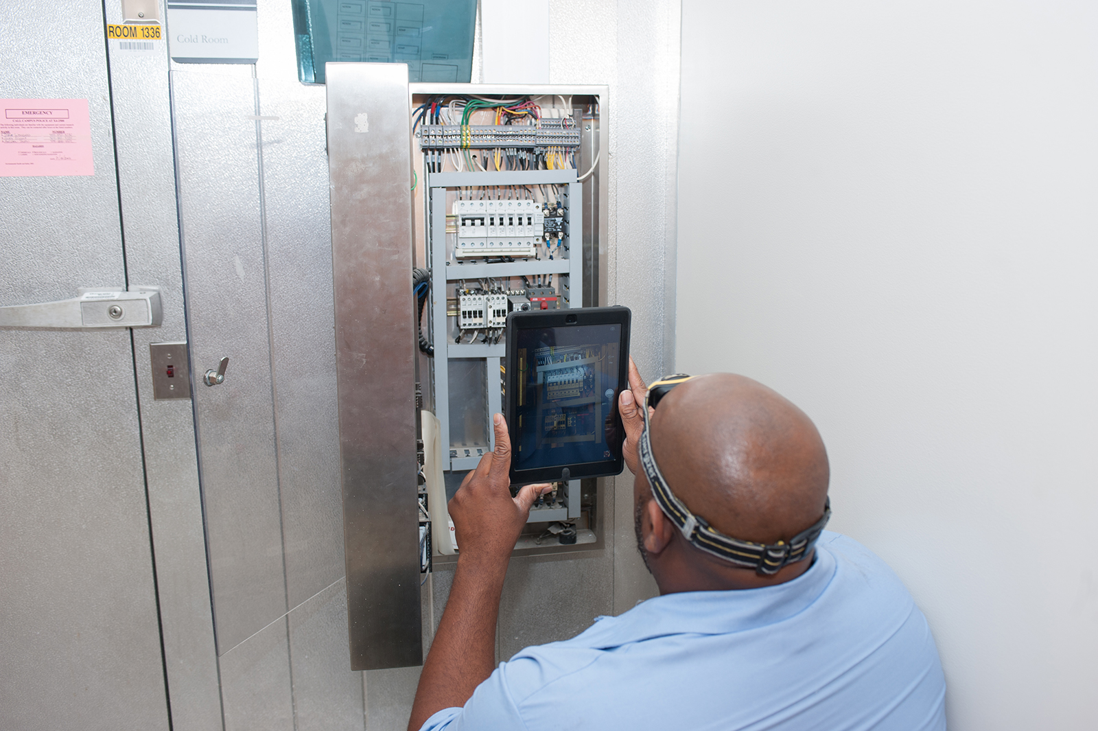 Maintenance Worker Keino King uses an iPad to document maintenance work at the Ford ES&amp;T Building. The software lets users look up information about the equipment they are working on at any given time.