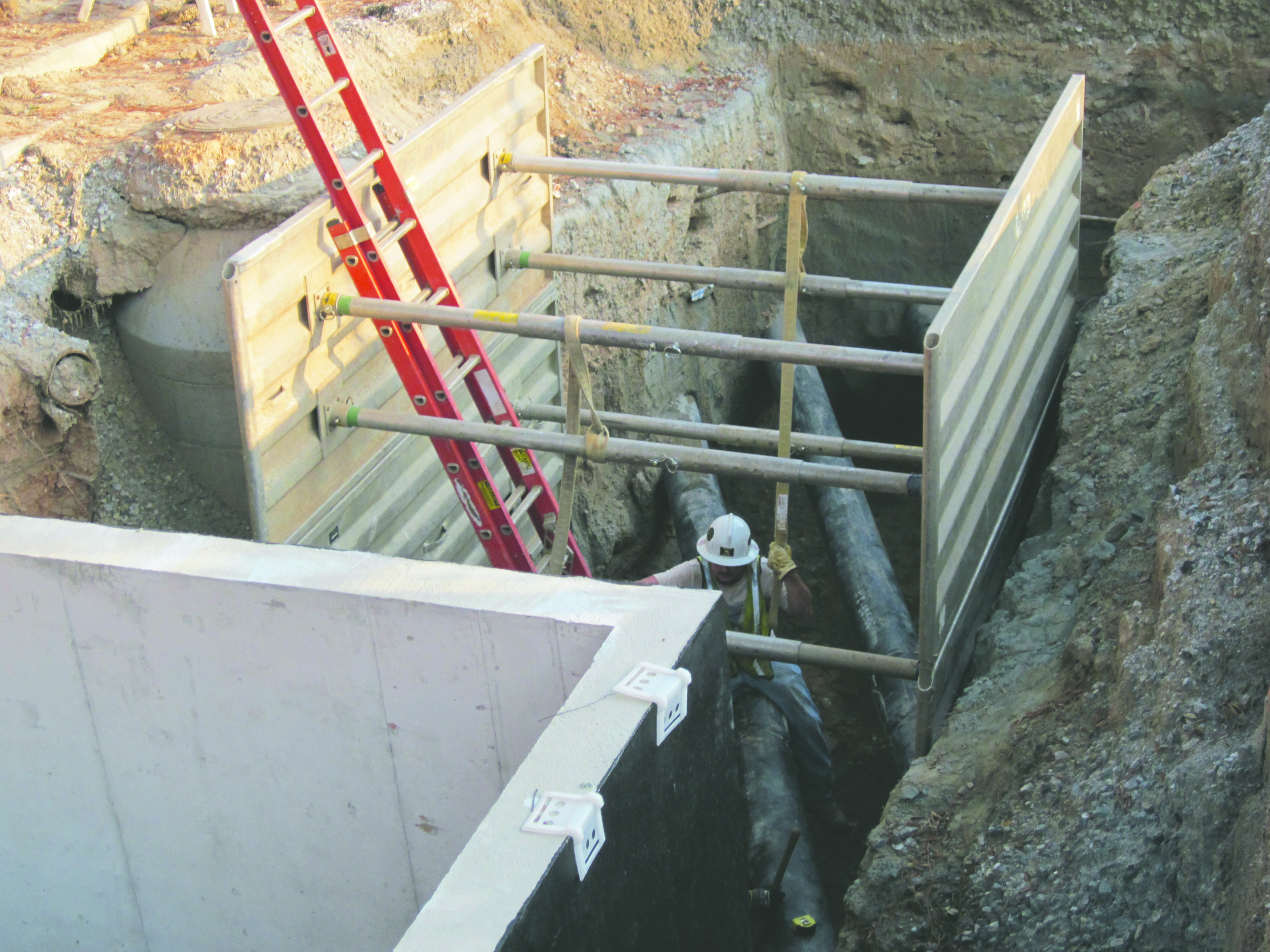 A contractor works with newly installed steam piping.