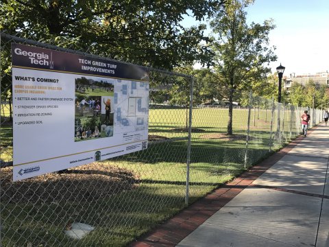 Tech Green fence with sign 